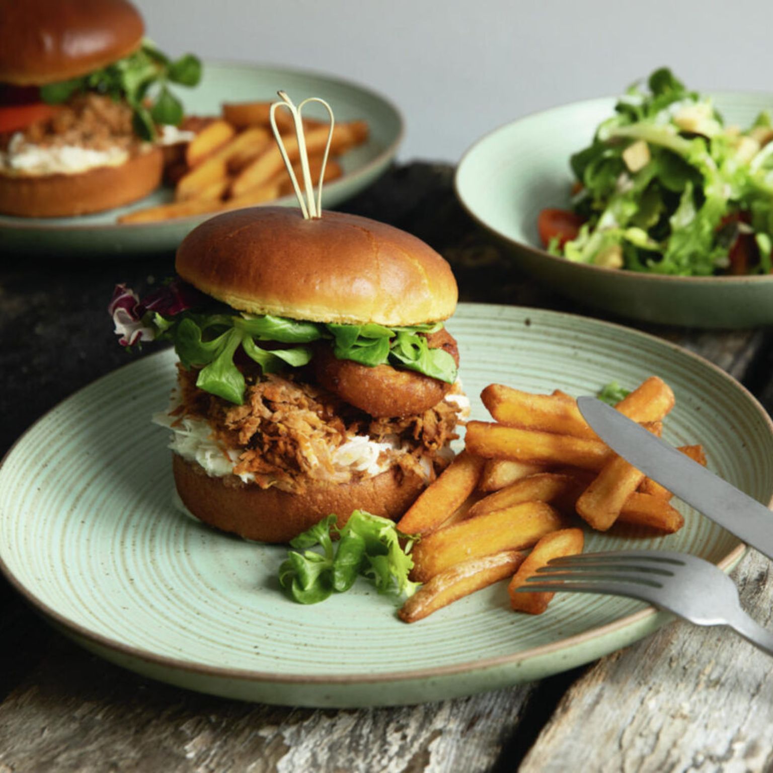 a burger on a green Thomas Nature plate with fries